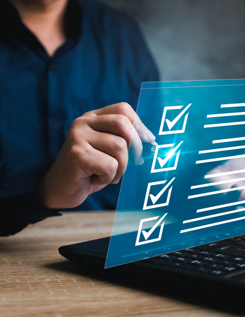 Image of someone checking boxes on computer form laptop